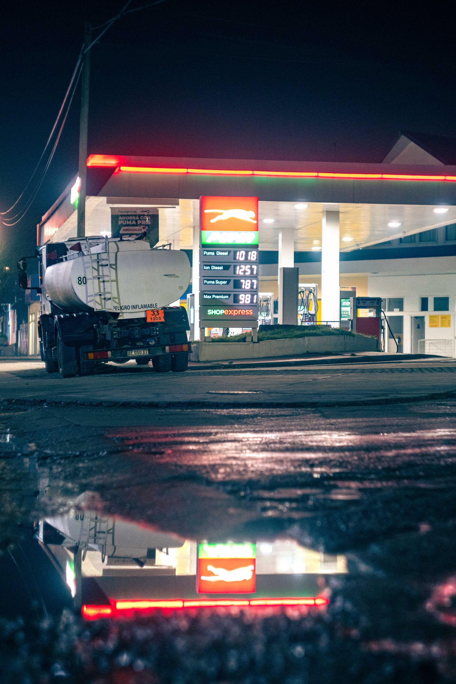 Diesel being pumped into a heavy-duty truck at dusk at an industrial fuel depot